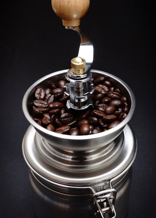 Fresh coffee beans in a coffee grinderの写真素材