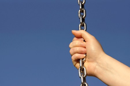 Woman hand and steel chainの写真素材