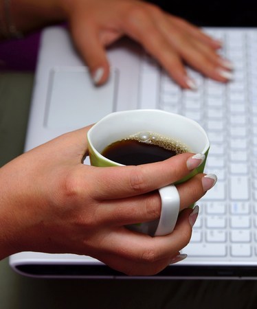 Coffee cup in a beautiful woman's handの写真素材