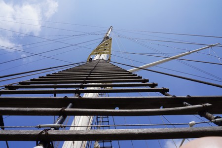 Main mast of a sailing ship under blue sky