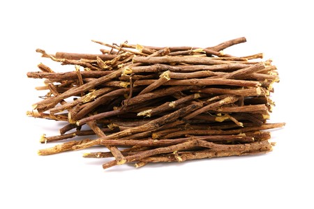 Licorice root sticks lie on a wooden tableの写真素材