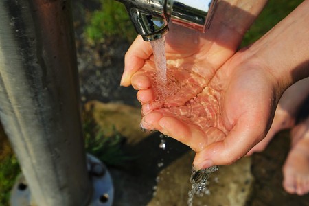 Woman hands on a beach showerの写真素材