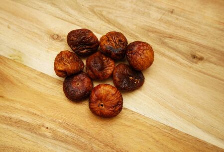 Some dried figs on a wooden board