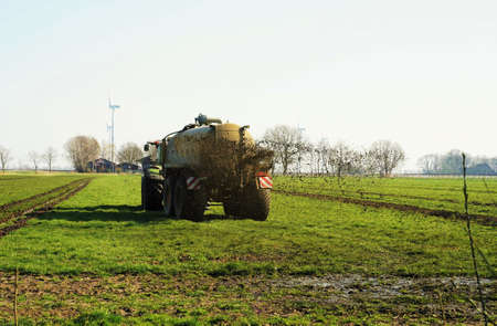 Tractor in March drives manure on the field