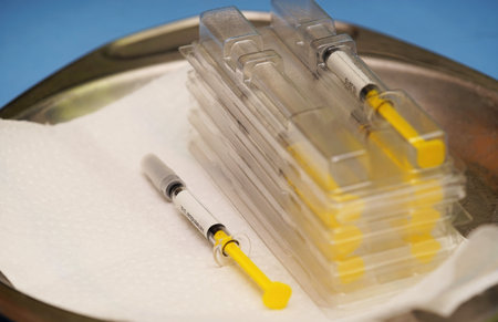 Syringes on a blue background in a hospitalの写真素材