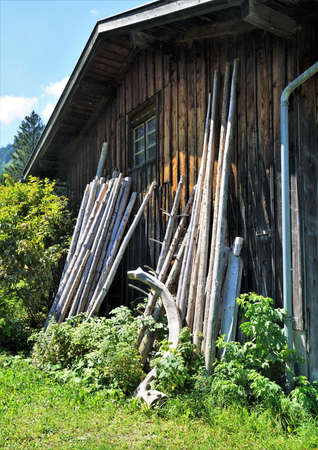 Wooden shed on a meadow under a blue skyの写真素材