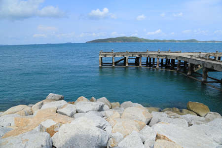 Pier by the sea and rocks at Rayong, Thailandの写真素材