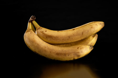 Bunch of bananas isolated on black background. Close-up.の写真素材