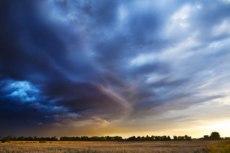 Sunset. Dark clouds coming from the south announce the weather change, possible storm.の写真素材