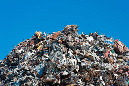 Pile of scrap metal over blue sky.の写真素材