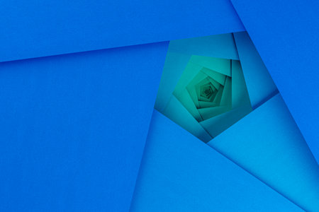 Layered spiral pattern of blue cardboard sheets forms a pentagonal shape. The spirals create a sense...