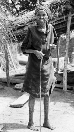 PORTO-NOVO, BENIN - MAR 8, 2012: Unidentified Beninese old woman tries to smile for the camera. People of Benin suffer of poverty due to the difficult economic situation.のeditorial素材