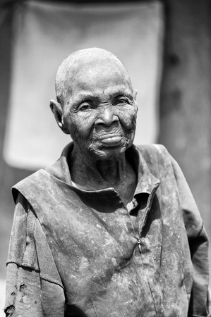 PORTO-NOVO, BENIN - MAR 8, 2012: Unidentified Beninese hairless woman smiles sincerely. People of Benin suffer of poverty due to the difficult economic situation.のeditorial素材