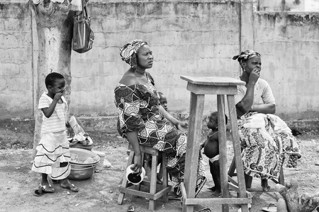 PORTO-NOVO, BENIN - MAR 8, 2012: Unidentified Beninese women sell at the market. People of Benin suffer of poverty due to the difficult economic situation.のeditorial素材