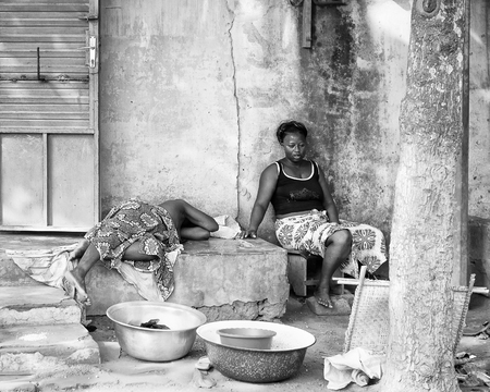 PORTO-NOVO, BENIN - MAR 8, 2012: Unidentified Beninese women take siesta. People of Benin suffer of poverty due to the difficult economic situation.のeditorial素材
