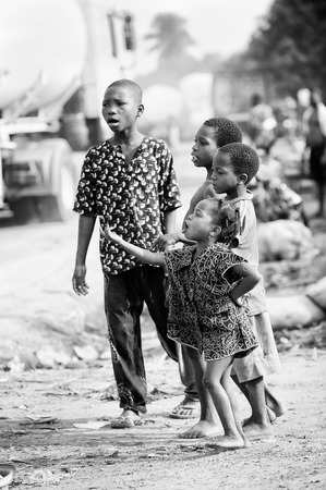 PORTO-NOVO, BENIN - MAR 8, 2012: Unidentified Beninese children in the street. People of Benin suffer of poverty due to the difficult economic situation.のeditorial素材