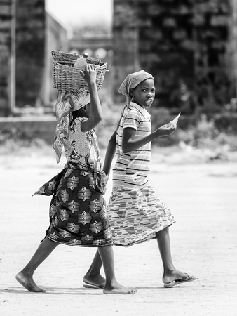 PORTO-NOVO, BENIN - MAR 9, 2012: Unidentified Beninese woman with different stuff over the head....