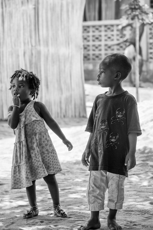 KARA, TOGO - MAR 9, 2013: Unidentified Togolese boy and girl playing in the street. Children in Togo suffer of poverty due to the unstable econimic situationのeditorial素材