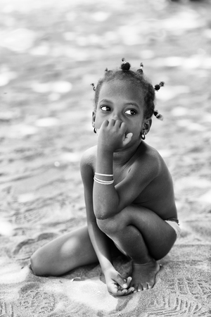 KARA, TOGO - MAR 9, 2013: Unidentified Togolese cute little girl in the street. Children in Togo suffer of poverty due to the unstable econimic situationのeditorial素材