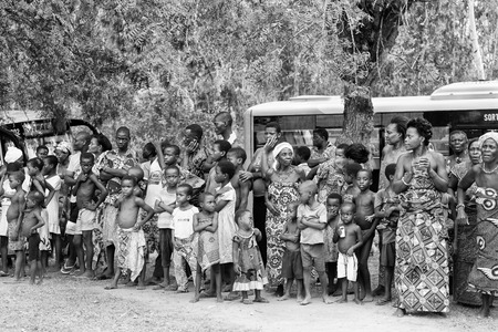 KARA, TOGO - MAR 9, 2013: Unidentified Togoles children watch a local show. People in Togo suffer of poverty due to the unstable econimic situationのeditorial素材