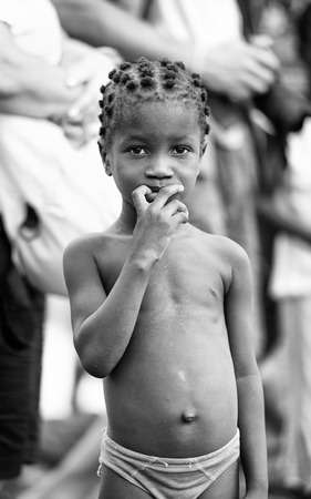 KARA, TOGO - MAR 9, 2013: Unidentified Togolese girl portrait in the street. Children in Togo suffer of poverty due to the unstable econimic situationのeditorial素材