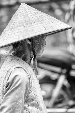 SAPA, VIETMAN - SEP 22, 2014: Unidentified Hmong woman in a rice hat in Sapa, Vietnam. Hmong is a minority ethnic group of Vietnamのeditorial素材