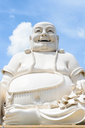 MY THO, VIETNAM - OCT 5, 2014: Massive statue of the Sitting Smiling Buddha at the Vinh Tranh Pagoda in My Tho, the Mekong Delta,のeditorial素材
