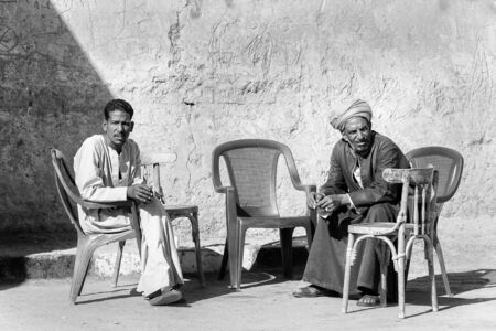 ASWAN, EGYPT - DEC 2, 2014: Unidentified Egyptian men sit on the chairs. 90 of Egyptian people are Muslimのeditorial素材