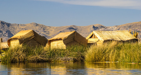 Hand made houses in Uros, artificial islands made of floating reeds, Peru, South America.の写真素材