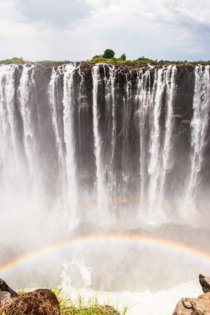 Rainbow over the Victoria Falls, boarder of Zambia and Zimbabwe.の写真素材