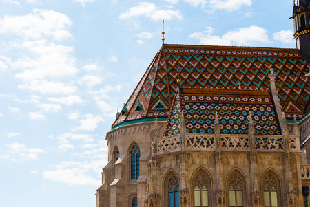 Matthias Church, a church located in Budapest, Hungary, in front of the Fishermans Bastion at the heart of Budas Castle District.の写真素材