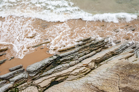 Sea and the rock over the sand beach