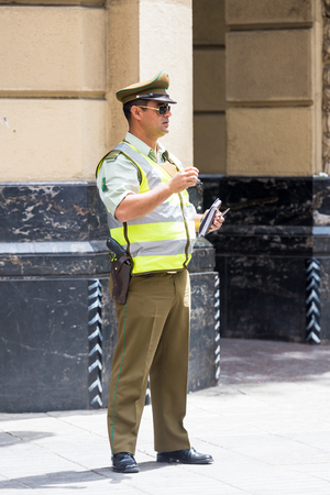SANTIAGO, CHILE - NOV 1, 2014:  Unidentified policeman in the street in Santiago. Chilean people are mainly of mixed Spanish and Amerindian descentのeditorial素材
