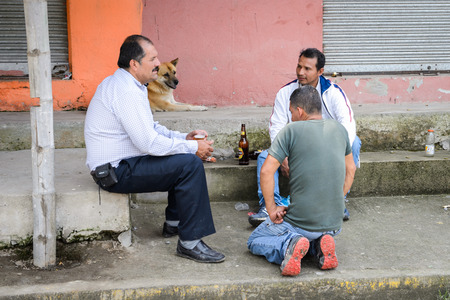 MINDO, ECUADOR - JAN 1, 2015: Unidentified Ecuadorian men talk in the street. 71,9% of Ecuadorian people belong to the Mestizo ethnic groupのeditorial素材