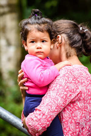 MINDO, ECUADOR - JAN 1, 2015: Unidentified Ecuadorianwoman with a baby. 71,9% of Ecuadorian people belong to the Mestizo ethnic groupのeditorial素材