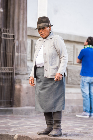 QUITO, ECUADOR - JAN 2, 2015: Unidentified Ecuadorian woman in a bowler hat in the street in Quito. 71,9% of Ecuadorian people belong to the Mestizo ethnic groupのeditorial素材
