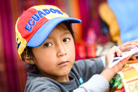 OTAVALO, ECUADOR - JAN 3, 2015: Unidentified Ecuadorian boy in a hat of Ecuador at the Otavalo Market. 71,9% of Ecuadorian people belong to the Mestizo ethnic groupのeditorial素材