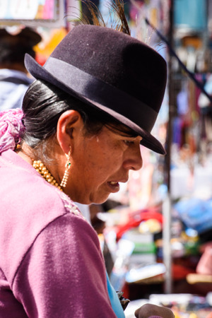 OTAVALO, ECUADOR - JAN 3, 2015: Unidentified Ecuadorian woman in traditional clothes works at the Otavalo Market. 71,9% of Ecuadorian people belong to the Mestizo ethnic groupのeditorial素材
