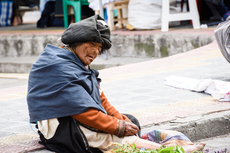 OTAVALO, ECUADOR - JAN 3, 2015: Unidentified Ecuadorian man in traditional clothes works at the Otavalo Market. 71,9% of Ecuadorian people belong to the Mestizo ethnic groupのeditorial素材