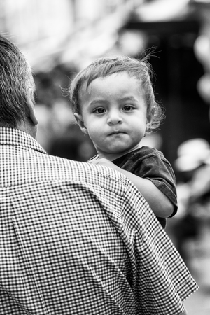 QUITO, ECUADOR - JAN 1, 2015: Unidentified Ecuadorian little girl watches on the camera. 71,9% of Ecuadorian people belong to the Mestizo ethnic groupのeditorial素材