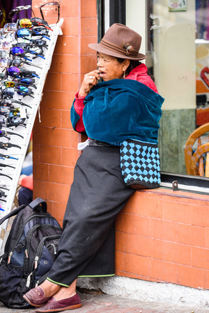 OTAVALO, ECUADOR - JAN 3, 2015: Unidentified Ecuadorian woman in traditional clothes works at the Otavalo Market. 71,9% of Ecuadorian people belong to the Mestizo ethnic groupのeditorial素材