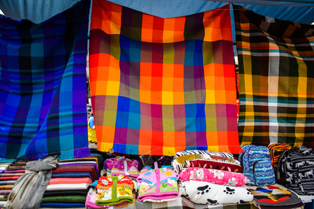 OTAVALO, ECUADOR - JAN 7, 2015: Colorful Souvenirs of the Otavalo market  designed and built in 1970 by Dutch architect Tonny Zwolloのeditorial素材