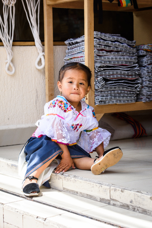 OTAVALO, ECUADOR - JAN 3, 2015: Unidentified Ecuadorian little girl in traditional clothes at the Otavalo Market. 71,9% of Ecuadorian people belong to the Mestizo ethnic groupのeditorial素材
