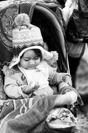 QUITO, ECUADOR - JAN 1, 2015: Unidentified Ecuadorian little girl in a baby carriage. 71,9% of Ecuadorian people belong to the Mestizo ethnic groupのeditorial素材