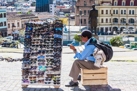 QUITO, ECUADOR - JAN 2, 2015: Unidentified Ecuadorian man sells sunglasses. 71,9% of Ecuadorian people belong to the Mestizo ethnic groupのeditorial素材
