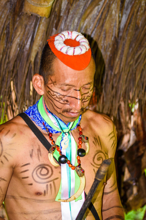 YASUNI, ECUADOR - JAN 4, 2015:  Unidentified Ecuadorian indian makes music. Indigenous indians  are protected by COICA (Coordinator of Indigenous Organizations of the Amazon River Basin)のeditorial素材
