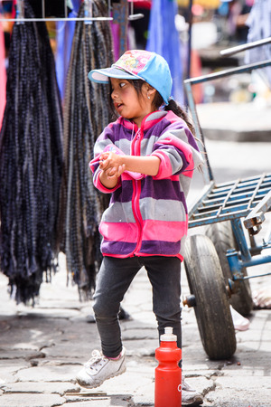 OTAVALO, ECUADOR - JAN 3, 2015: Unidentified Ecuadorian little girl at the Otavalo Market. 71,9% of Ecuadorian people belong to the Mestizo ethnic groupのeditorial素材