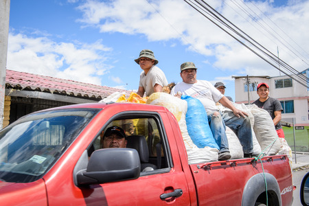 RIOBAMBA, ECUADOR - JAN 7, 2015: Unidentified Ecuadorian people in a truck. 71,9% of Ecuadorian people belong to the Mestizo ethnic groupのeditorial素材