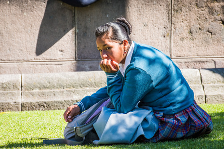 QUITO, ECUADOR - JAN 2, 2015: Unidentified Ecuadorian woman sits on the grass. 71,9% of Ecuadorian people belong to the Mestizo ethnic groupのeditorial素材