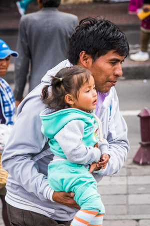 QUITO, ECUADOR - JAN 2, 2015: Unidentified Ecuadorian man and her little daughter. 71,9% of Ecuadorian people belong to the Mestizo ethnic groupのeditorial素材